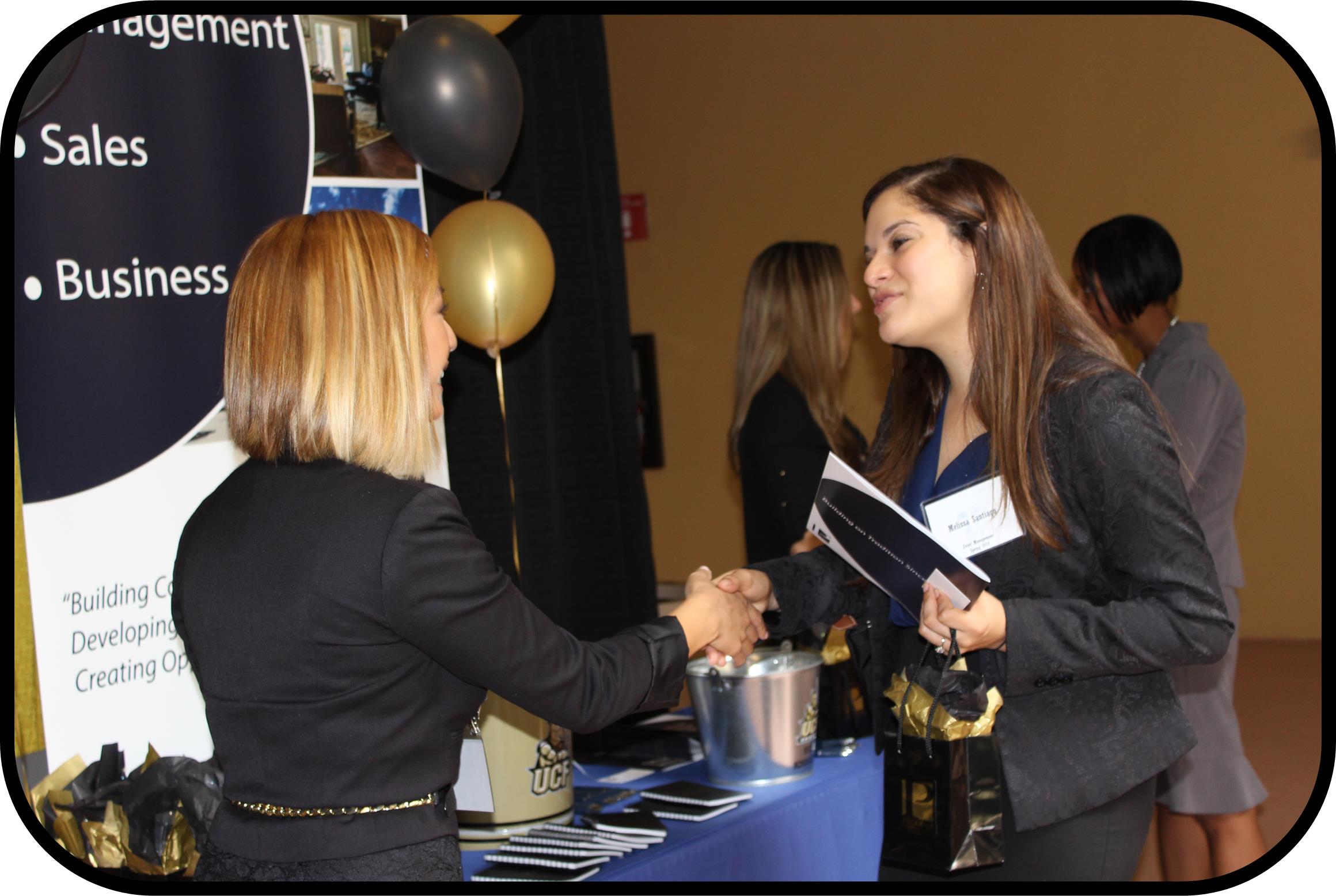 Female college student speaking with an employer at a Career Fair